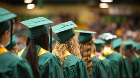 Backshot of college graduates at a graduation ceremony. 