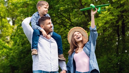 A family playing with a toy airplane. 
