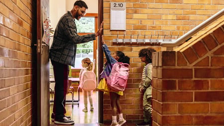 A teacher high-fiving a young student